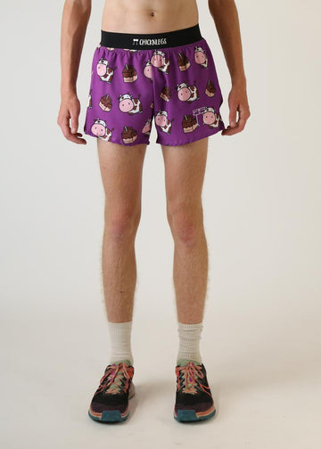 Model wearing Chicknlegs men's 4 inch split running shorts choccy cow design front view