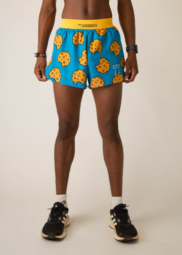 Model wearing Chicknlegs in mens 4 inch split running shorts in the cookies design, facing front.
