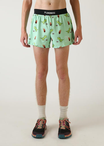 Model wearing Chicknlegs men's 4 inch split running shorts in dinos design front view