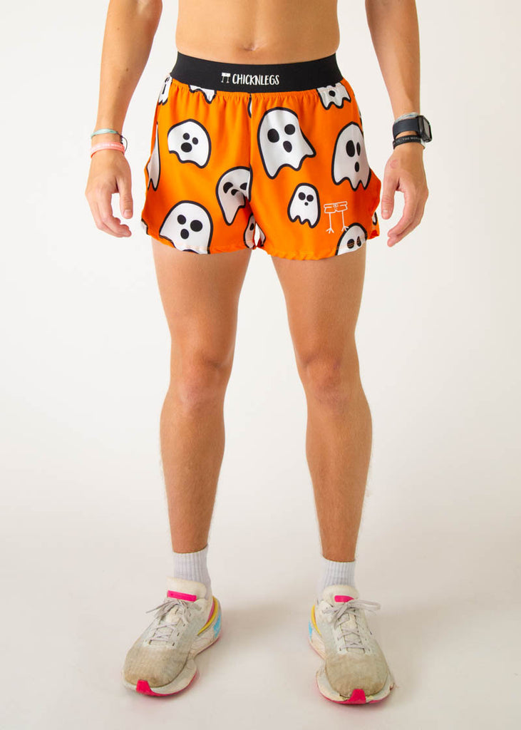 The model is a runner wearing Chicknlegs men's 4 inch split running shorts in the Ghost design, facing front.
