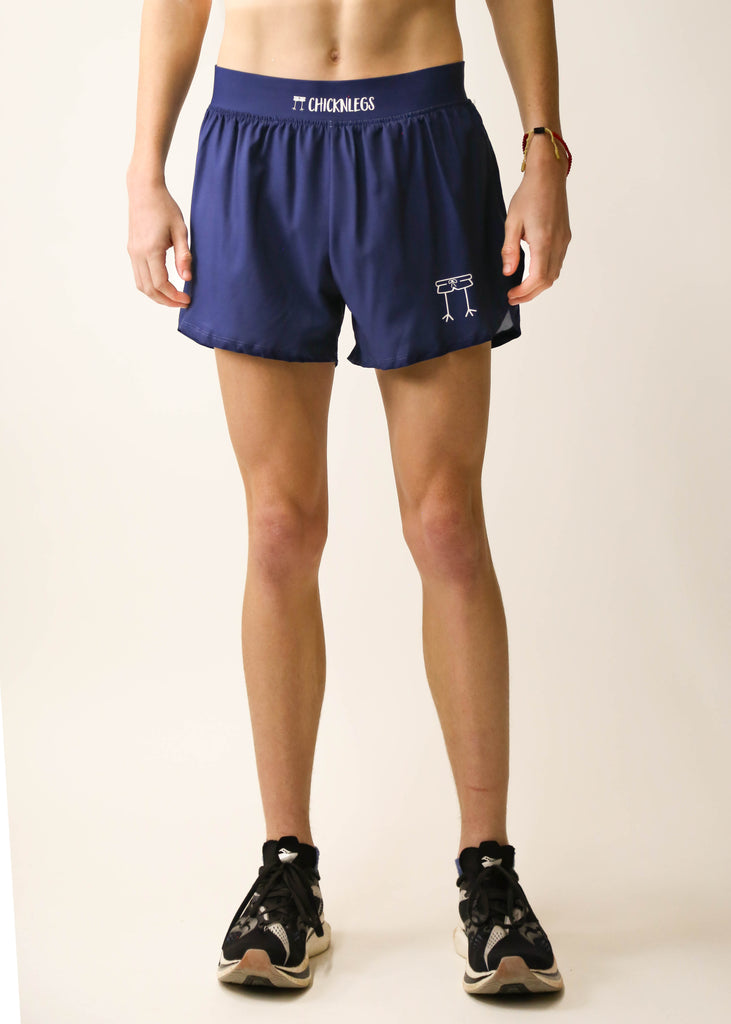 Model is a runner wearing Chicknlegs men's 4 inch split running shorts in the navy blue design facing front.