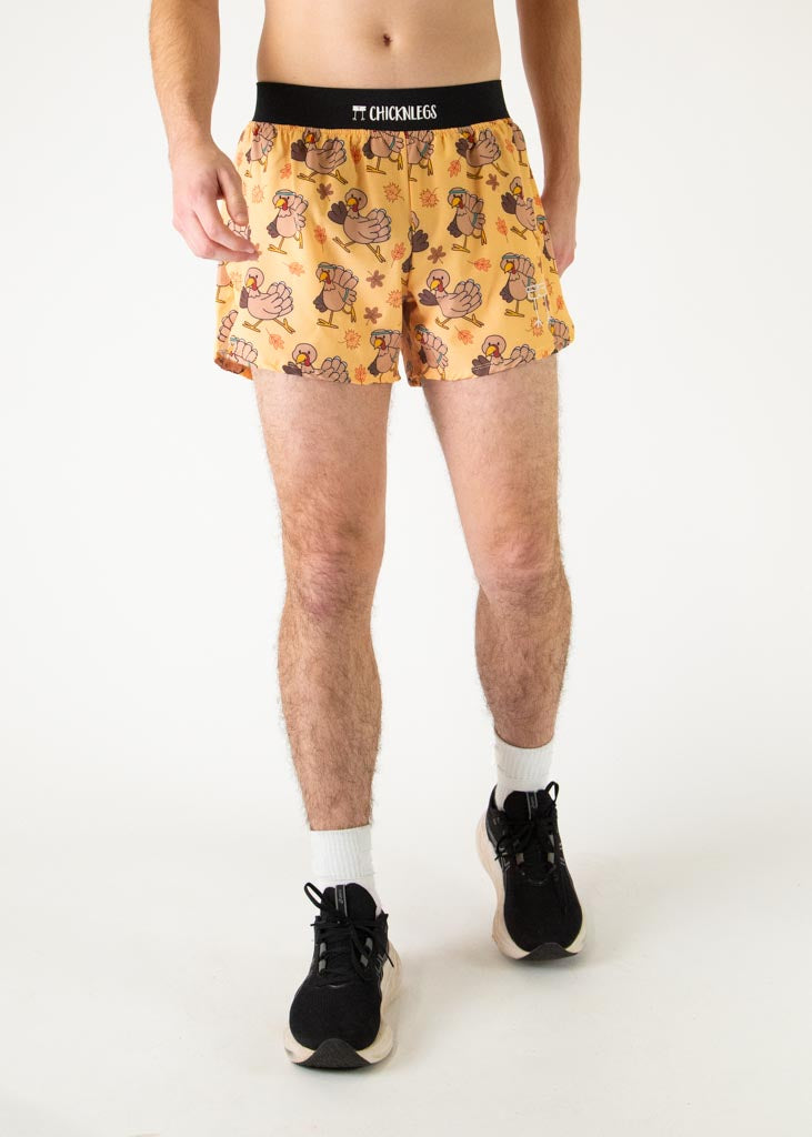 The model is a runner who is wearing Chicknlegs men's 4 inch split running shorts in the pardoned turkey design, facing front.