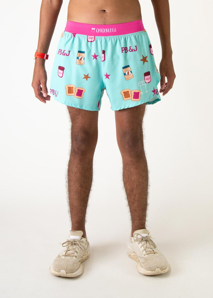 The model is a runner who is wearing Chicknlegs men's 4 inch split running shorts in the PB&J design, facing front.