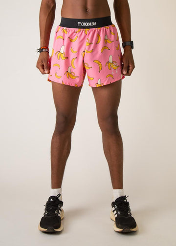 Model wearing Chicknleg's mens 4 inch split running shorts in the pink banana design, facing front.