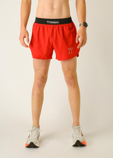 Model is wearing Chicknlegs men's 4 inch split running shorts in the red design, facing front.