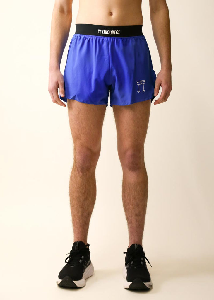 Model wearing Chicknlegs men's 4 inch split running shorts in the royal blue design, facing front.