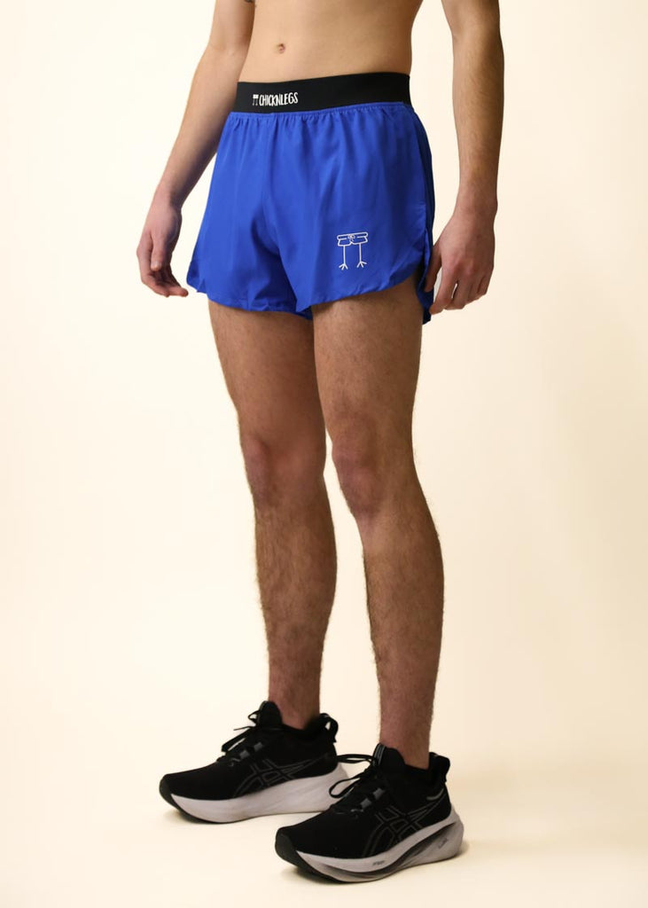 Model wearing Chicknlegs men's 4 inch split running shorts in the royal blue design, facing left for side view.