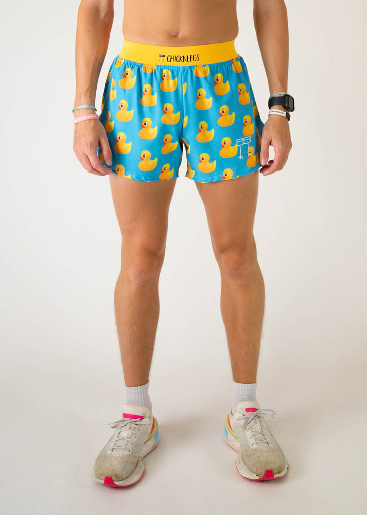 The model is a runner wearing Chicknlegs in the men's 4 inch split running shorts in the rubber ducky design, facing front.
