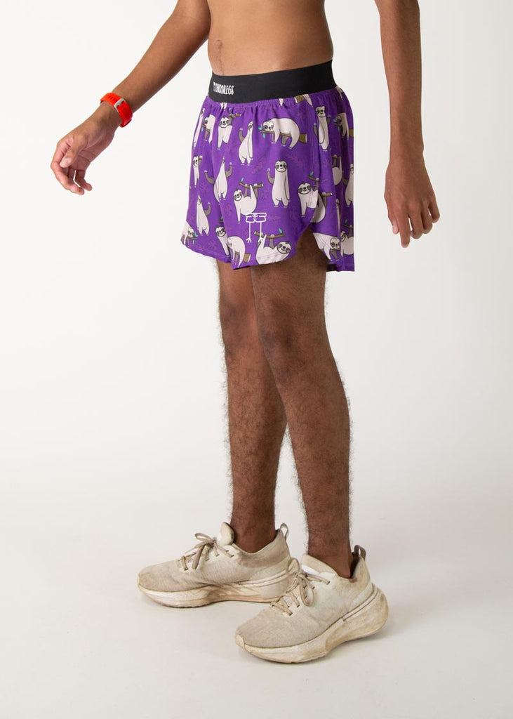 The model is a runner who is wearing Chicknlegs men's 4 inch split running shorts in the sloth design, facing left.