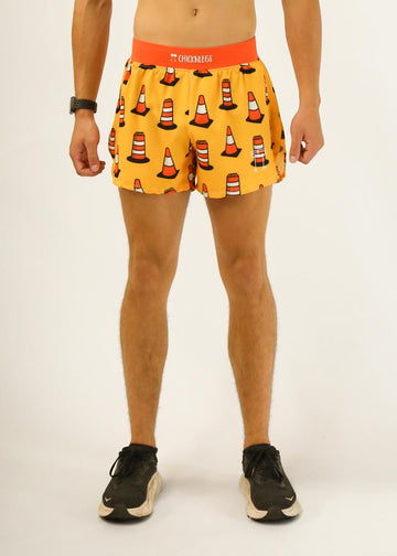 Model is a runner wearing Chicknlegs men's 4 inch split running shorts in the traffic cones design, facing front.