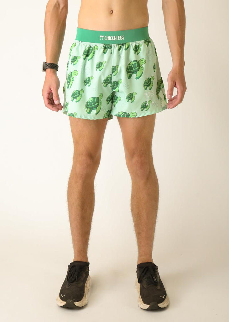 Model is a runner who is wearing Chicknlegs men's 4 inch split running shorts in the turtles design, facing front.