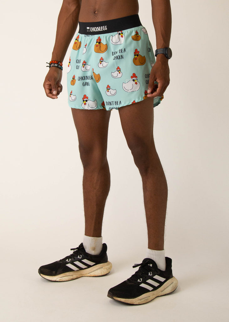 Model wearing Chicknlegs in mens 4 inch split running shorts in the swaggy chickns design, facing left.
