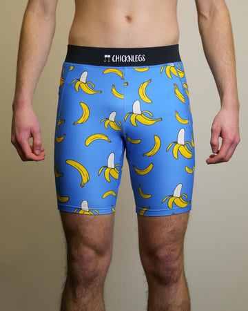 Runner is wearing ChicknLegs in the men's 8 in half tights with pockets in the blue bananas design. The print has fun yellow bananas on a solid blue background.