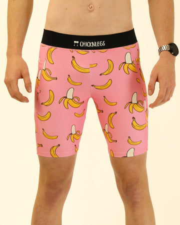 Runner is wearing ChicknLegs in the men's 8 in half tights with pockets in the pink bananas design. The print has fun yellow bananas on it with a light pink solid background.