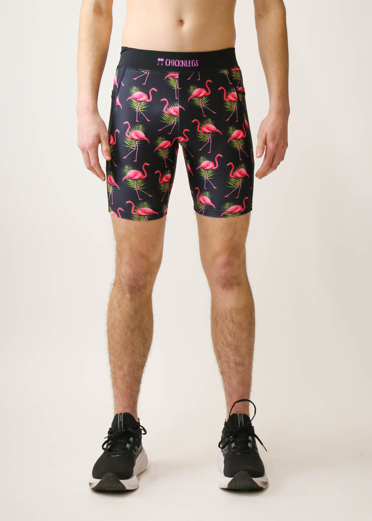 Model is a runner wearing Chicknlegs men's 8 inch half tight with the black flamingo design, facing front.