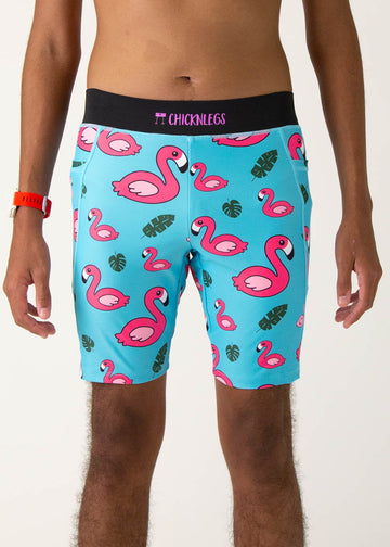 Model is a runner wearing Chicknlegs men's 8 inch half tights in the Blue Flamingo design, facing front.