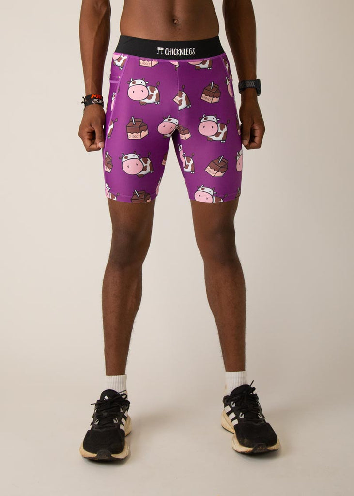 Model wearing Chicknlegs men's 8 inch half tights in the choccy cow design, facing front. 