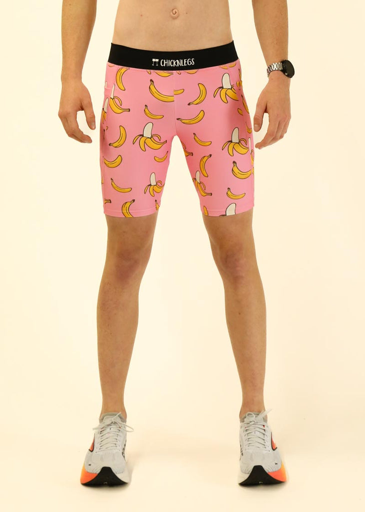 Model wearing Chicknlegs men's 8 inch half tights in the pink bananas design facing front.