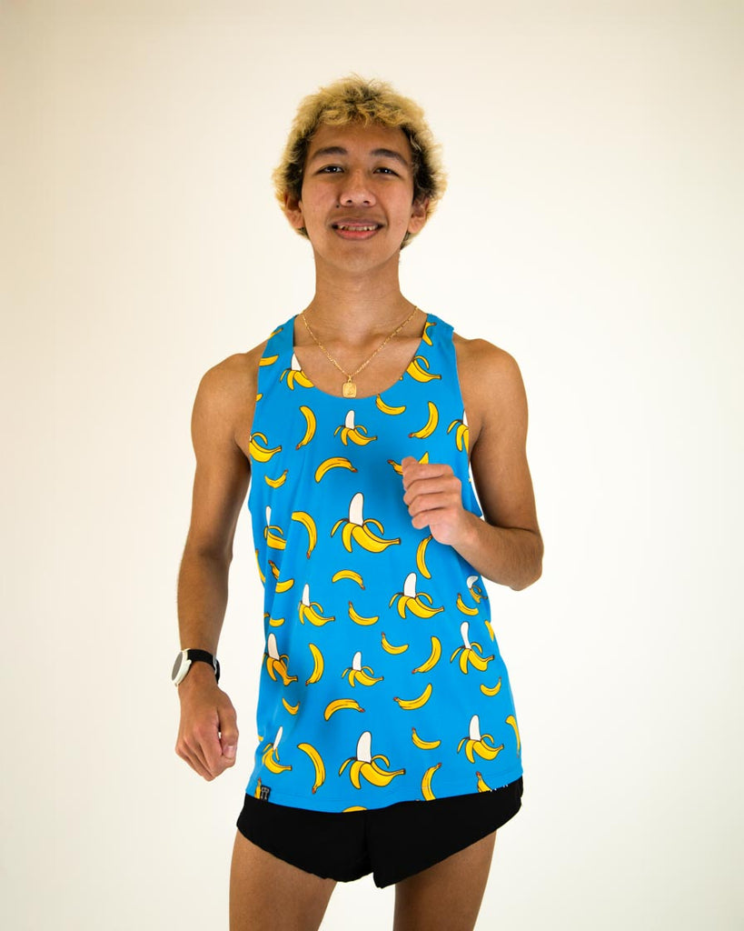 Runner is wearing ChicknLegs men's performance singlet in the blue banana design. The print has yellow bananas on it with a nice blue background.