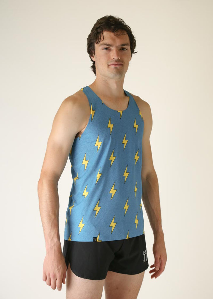 Model wearing Chicknlegs men's performance singlet wearing blue bolts design facing right.