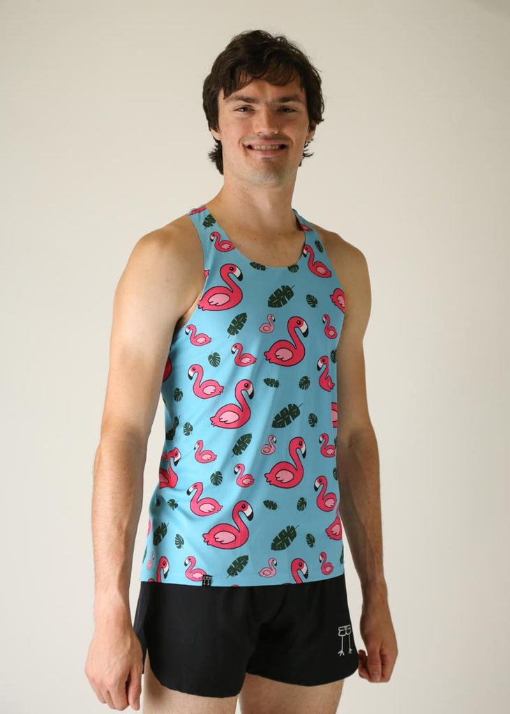 Model wearing Chicknlegs men's performance singlet wearing blue flamingo design right side view.