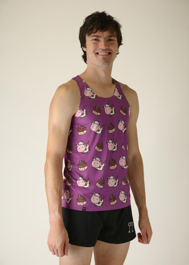 Model wearing chicknlegs men's performance singlet in choccy cow design right side view.