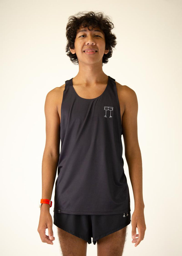 The model is a runner who is wearing Chicknlegs men's running performance singlet in the black design, facing front.