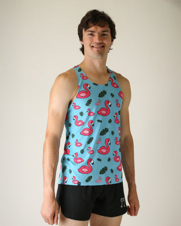 Runner is wearing ChicknLegs in the men's performance singlet in the blue flamingo design. The material is lightweight and has pink flamingos on it with green leaves and a blue background.