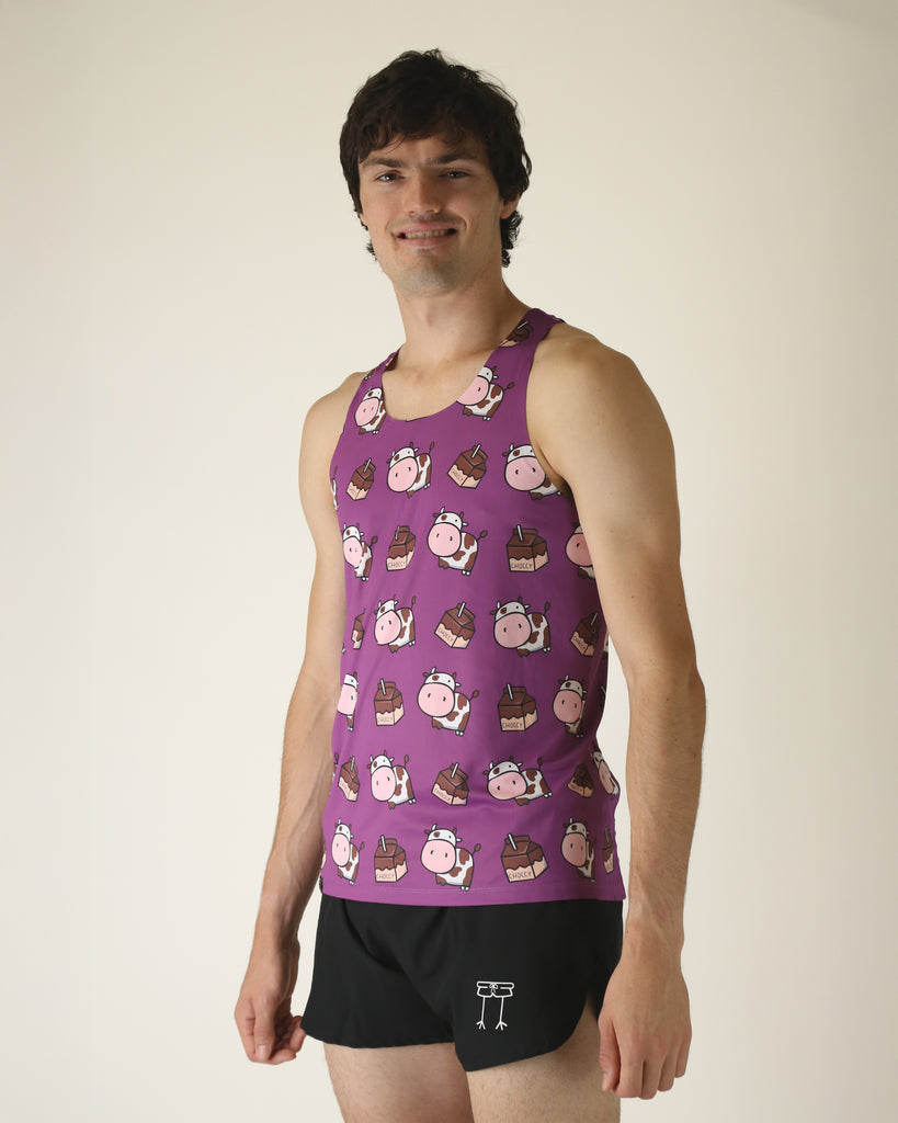 Runner is wearing ChicknLegs in the men's performance singlet that is lightweight and has the choccy cow design. The print has chocolate milk and brown cows on a purple background.