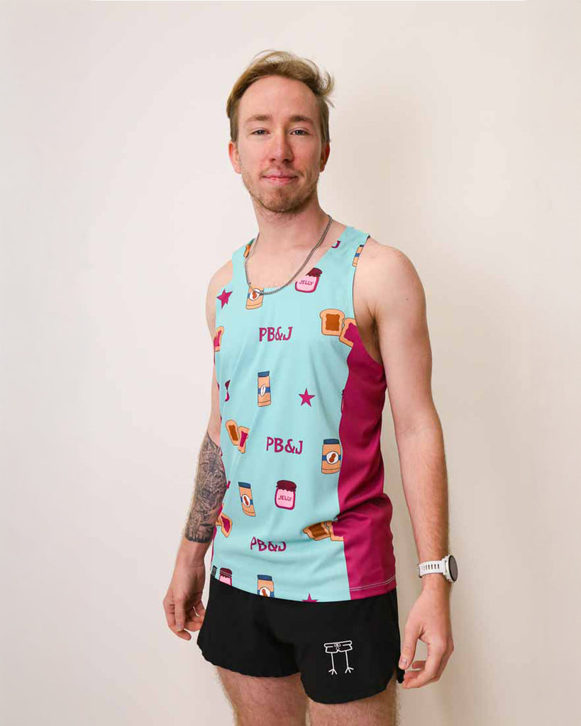 Runner is wearing ChicknLegs in the men's performance singlet that has purple side panels. The print has PB&J on it with peanut butter, toast, jelly, and stars.