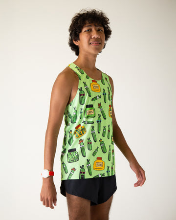 Runner is wearing ChicknLegs in the men's running performance singlet in the pickles design. The print has green background with pickles and a yellow and green jar.