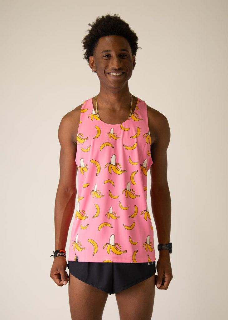 Model is wearing Chicknlegs men's runner singlet in the pink bananas design, facing front.