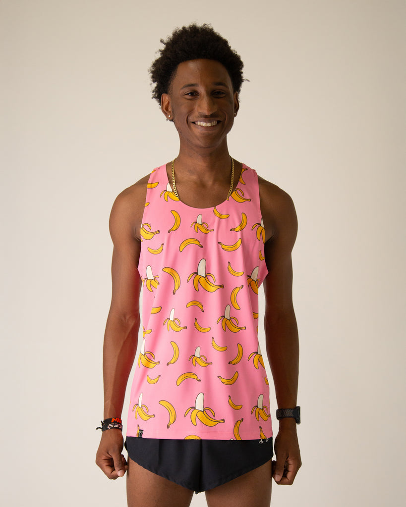 Runner is wearing ChicknLegs in the men's performance singlet in the pink bananas design. The print has yellow bananas and a pink background.