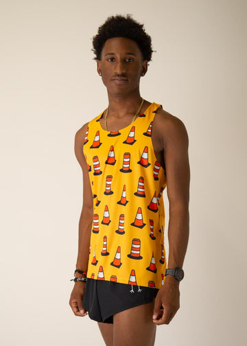 Model is wearing Chicknlegs men's runner singlet in the Traffic Cones design, facing left.