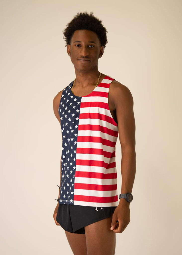 Model is wearing Chicknlegs men's runner singlet in the USA design, facing left.