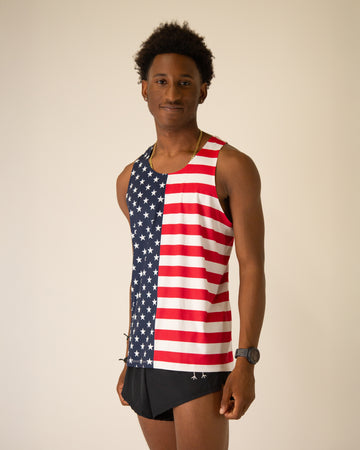 Runner is wearing ChicknLegs in the men's performance singlet in the USA State Flag design. The material is lightweight and great for runners who love America.