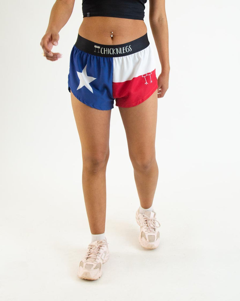 Runner is wearing ChicknLegs in the women's 1.5 in split running shorts in the texas flag print. It has blue, red and white on it.