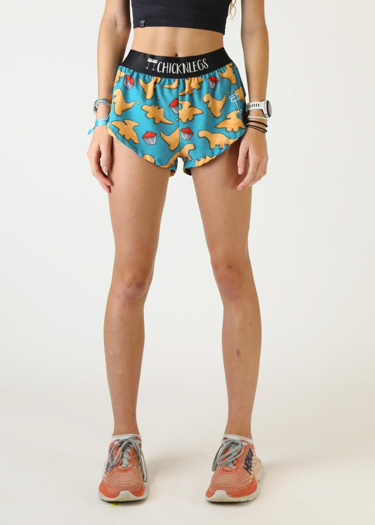 Model wearing Chicknlegs women's 1.5 inch split running shorts wearing dino nugget design front view