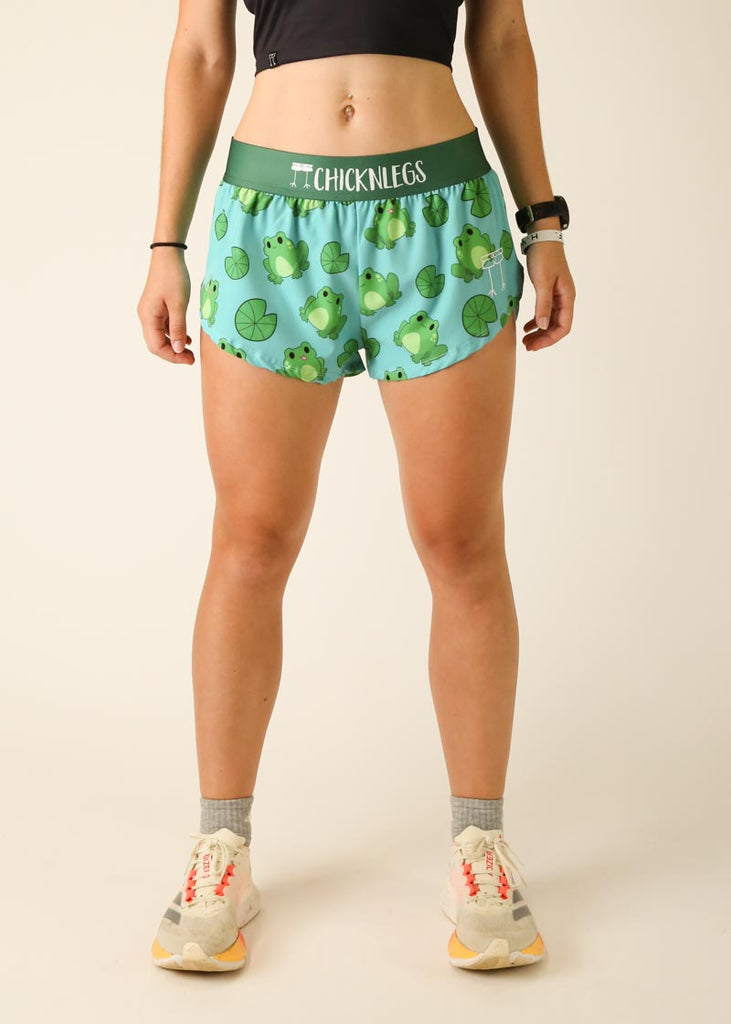 Model is wearing Chicknlegs women's 1.5 inch split running shorts in the Fartlek Froggies design, facing front.