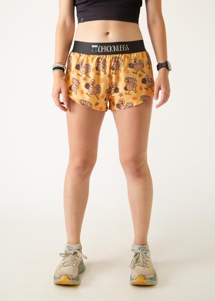 The model is a runner who is wearing Chicknlegs women's 1.5" split running shorts in the pardoned turkey design, facing front.
