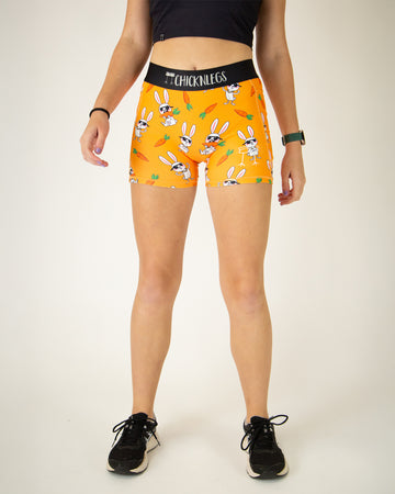 Runner is wearing ChicknLegs in the women's compression spandex in the bad bunny design, facing front. The print has white bunnys on it with sunglasses and carrots. 