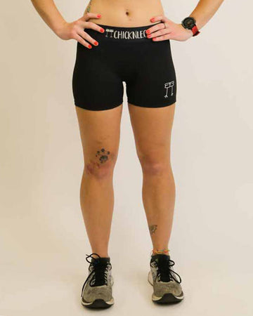 Runner is wearing ChicknLegs in the women's 3 in compression spandex shorts in the solid black design.