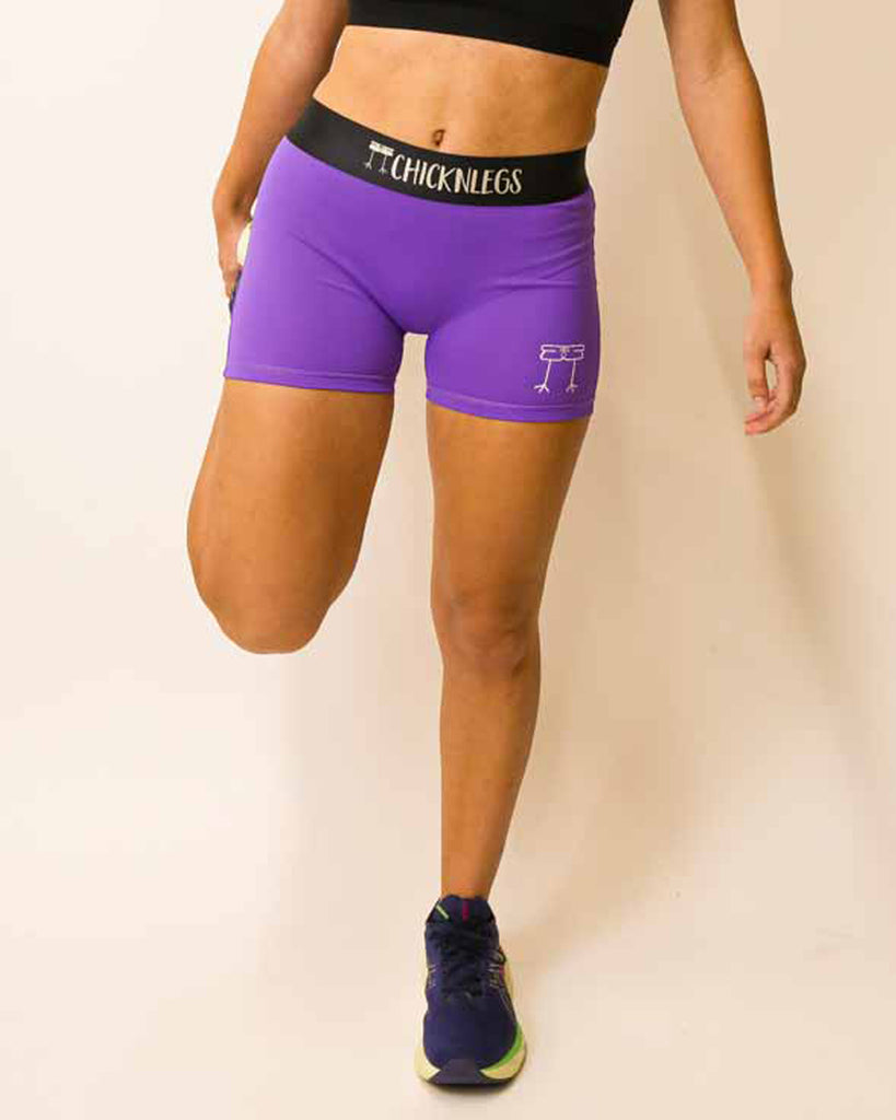 Runner is wearing ChicknLegs in the women's 3 in compression spandex shorts in the purple design.