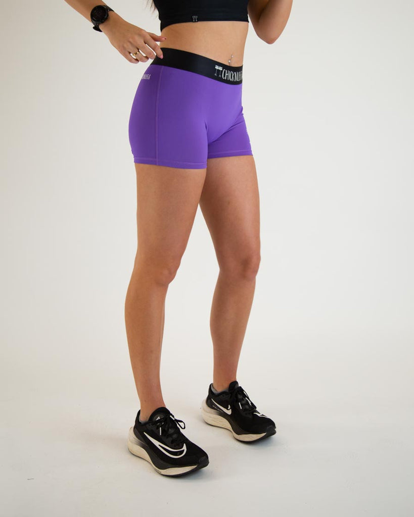 Runner is wearing ChicknLegs in the solid purple design with no pockets in the women's 3 in compression spandex shorts.