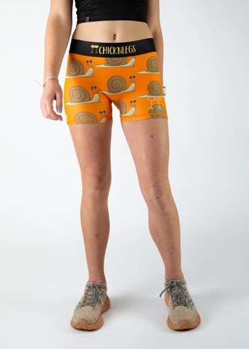 The model is a runner who is wearing Chicknlegs in the women's 3" compression shorts in the snails design, facing front.