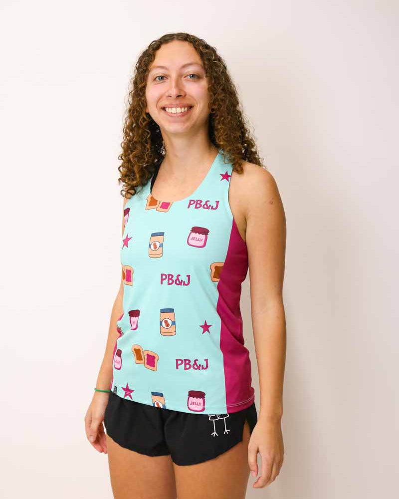 Runner is wearing ChicknLegs in the women's performance side panel singlet in the pb&j design. The print has peanut butter, jelly, and stars on it.