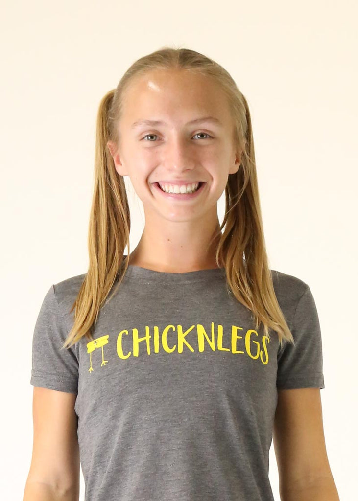 Model wearing Chicknleg's heather grey tee, facing front with a close up shot of the tee is shown.