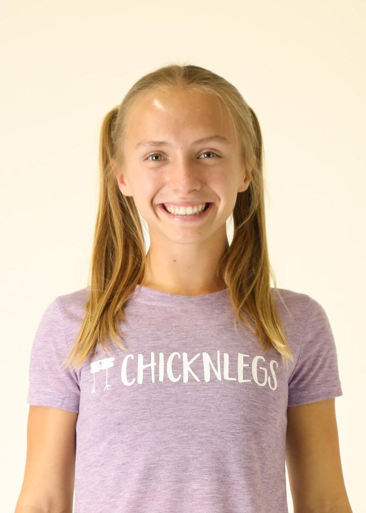 Model wearing Chicknleg's heather purple tee, facing front in a close up shot.