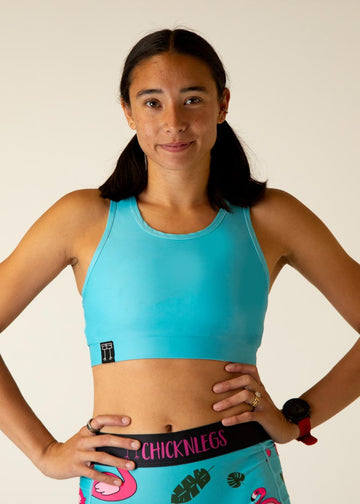 The model is a runner who is wearing Chicknlegs in the women's og sports bra, in the sky blue design. A close up is shown.