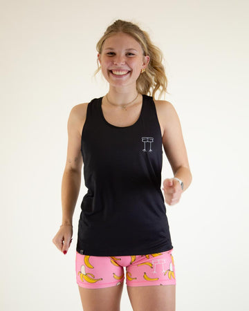 Runner is wearing ChicknLegs women's performance singlet in the solid black design.